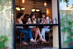 three women talking in a Tel Aviv cafe